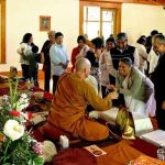 Blessing threads are given and received with great joy.