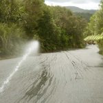 A cool hose on a hot carpark confirms the cross-fall grade into the drain.