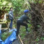 Natlie and Karmon Won give a #1 trim to the vegetation alongside the sala.