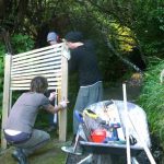 Three wise men working on the trellis out back of the sala built to give a more emphatic sense of privacy for the kuti.