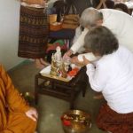 The eldest Elder blessing the Buddhas in Palmerston North as part of the new year celebration.