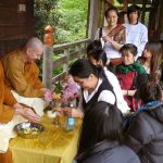 Ajahn Kusalo and Venerable Thitavijjo have their hands blessed - and again - and again. Awash with joy.