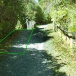 The track will be split just below the upper house to lower the very steep up-and-then-down on the longer loop track. The area in green will be removed.