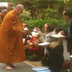 Offering alms to the Sangha.