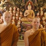 Ajahn Jayasaro and Ajahn Kusalo in front of one of the carved decorations in the new sala at Wat PahAmpawan.