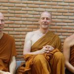 Ajahn Kevali and Kusalo and Tan Ari having a drink out back of the sala.