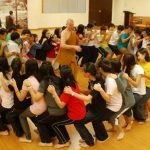 An active demonstration of paticca samupada. Each of the 50 teenagers seats is dependent on the knee of the one in front. The fun and laughter was dependent on a lack of timing. And we all fall down.