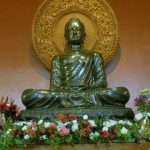 The main shrine at Bodhinyanarama festooned with flowers.