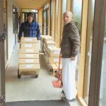 Cameron and Anagarika Colin making a start on moving the new shipment of books.