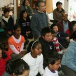 Children and adults alike listening to Ajahns explanation on the symbology of the Buddha rupa - prior to making lots of them.