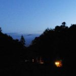 Looking toward the lower house on the way to morning puja. Stokes Valley lies in the distance.
