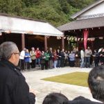 The faithful laity line the cloister ready to offer pindapat to the monks.